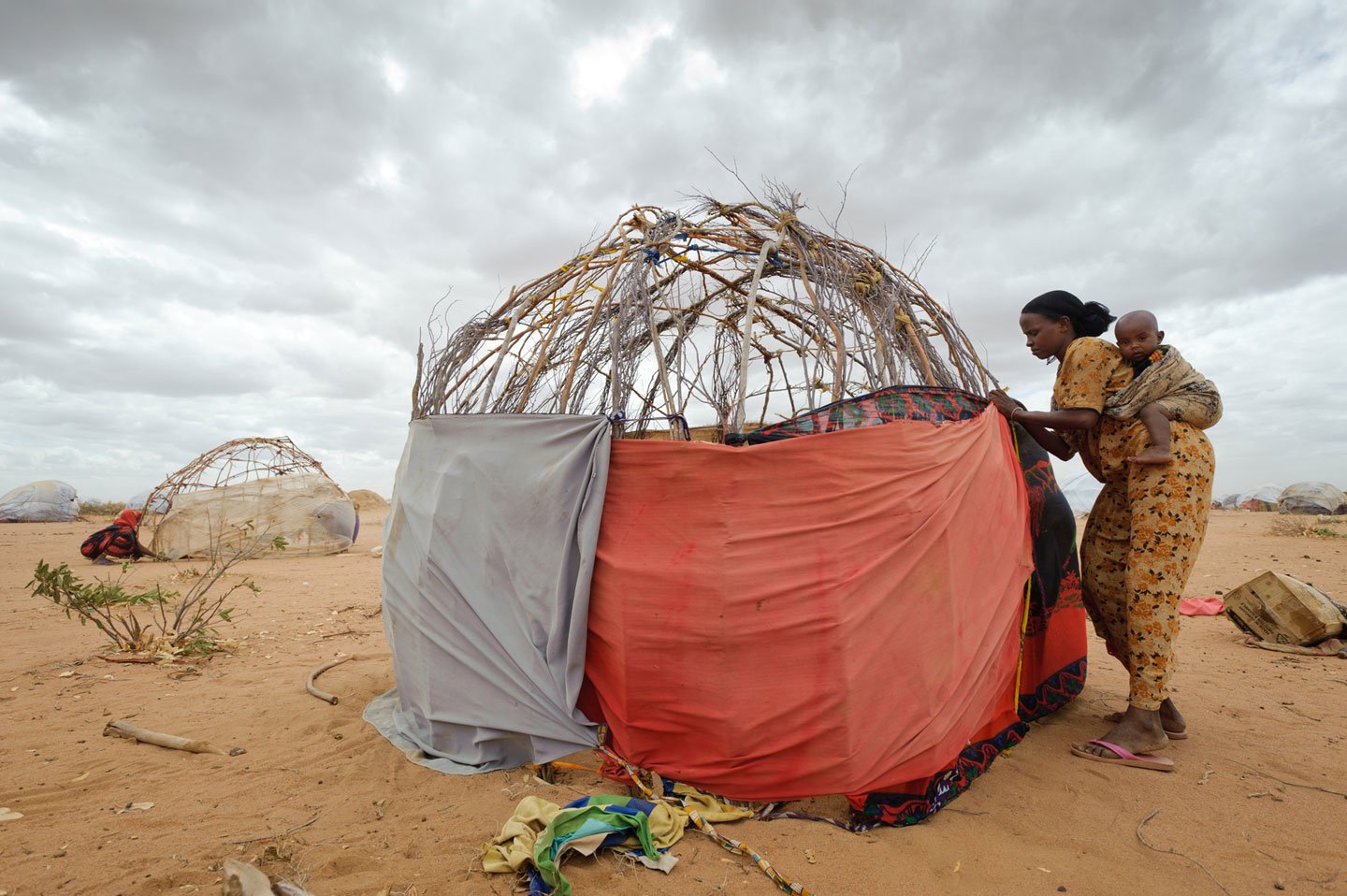 Reaching Dadaab, Isnino was exhausted but had to make her own hut out of sticks, borrowed clothing scraps, and burlap sacks that once contained relief food.
