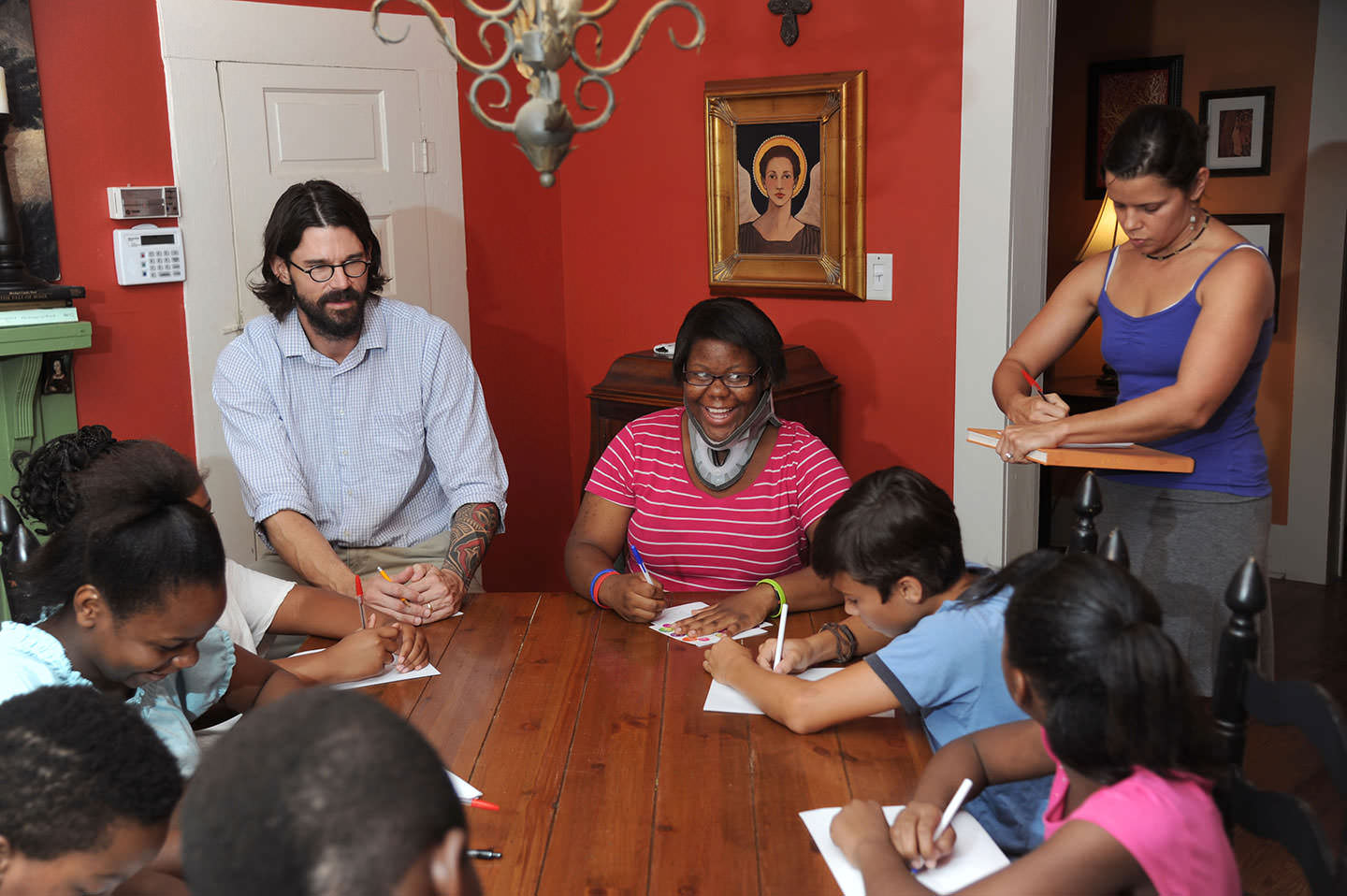 Adam Pierce, left, and Amy Pierce, far right, work with the kids from West Circle at the Brown House.