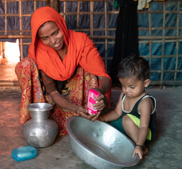 Woman and child washing opening soap