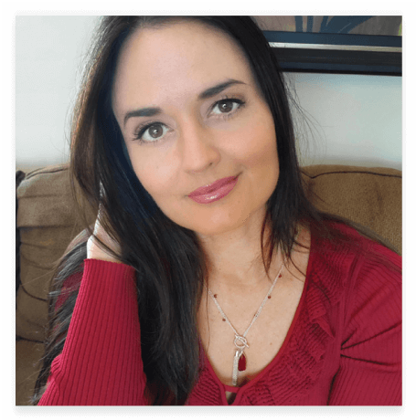 Headshot of Danica McKellar wearing her "Love and Grace" silver-toned necklace with ruby-colored-glass by Danica McKellar