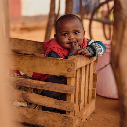 little boy sitting in a box