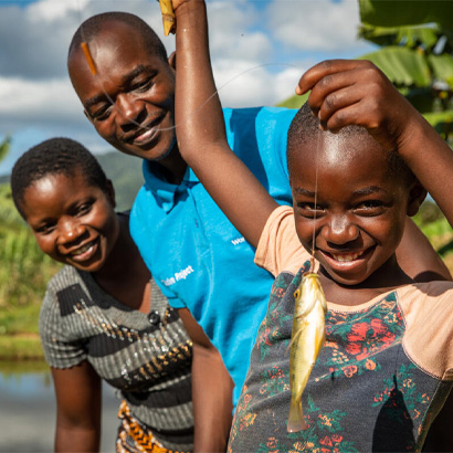 small child holding up a fish that was caught