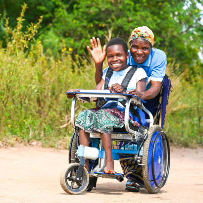 boy being pushed in wheelchair