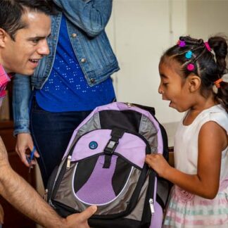Girl receives backpack from World Vision