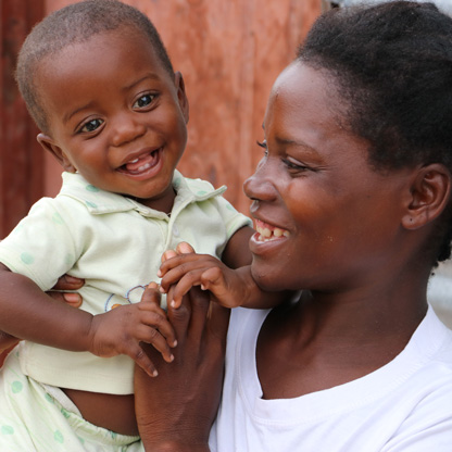 healthy child smiles and bonds with with his mother