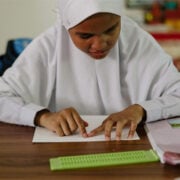girl reading in braille