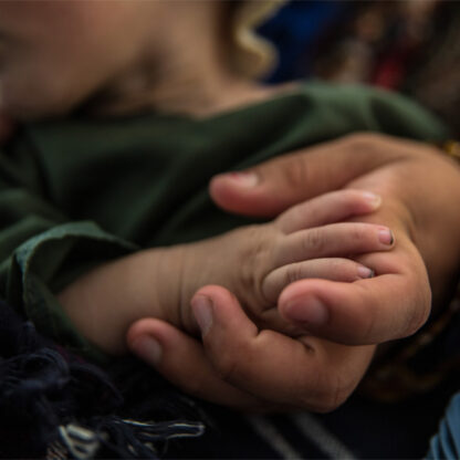 Hands of a mother and child dealing with the crisis in Afghanistan