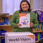 girl holding an item from the classroom kit