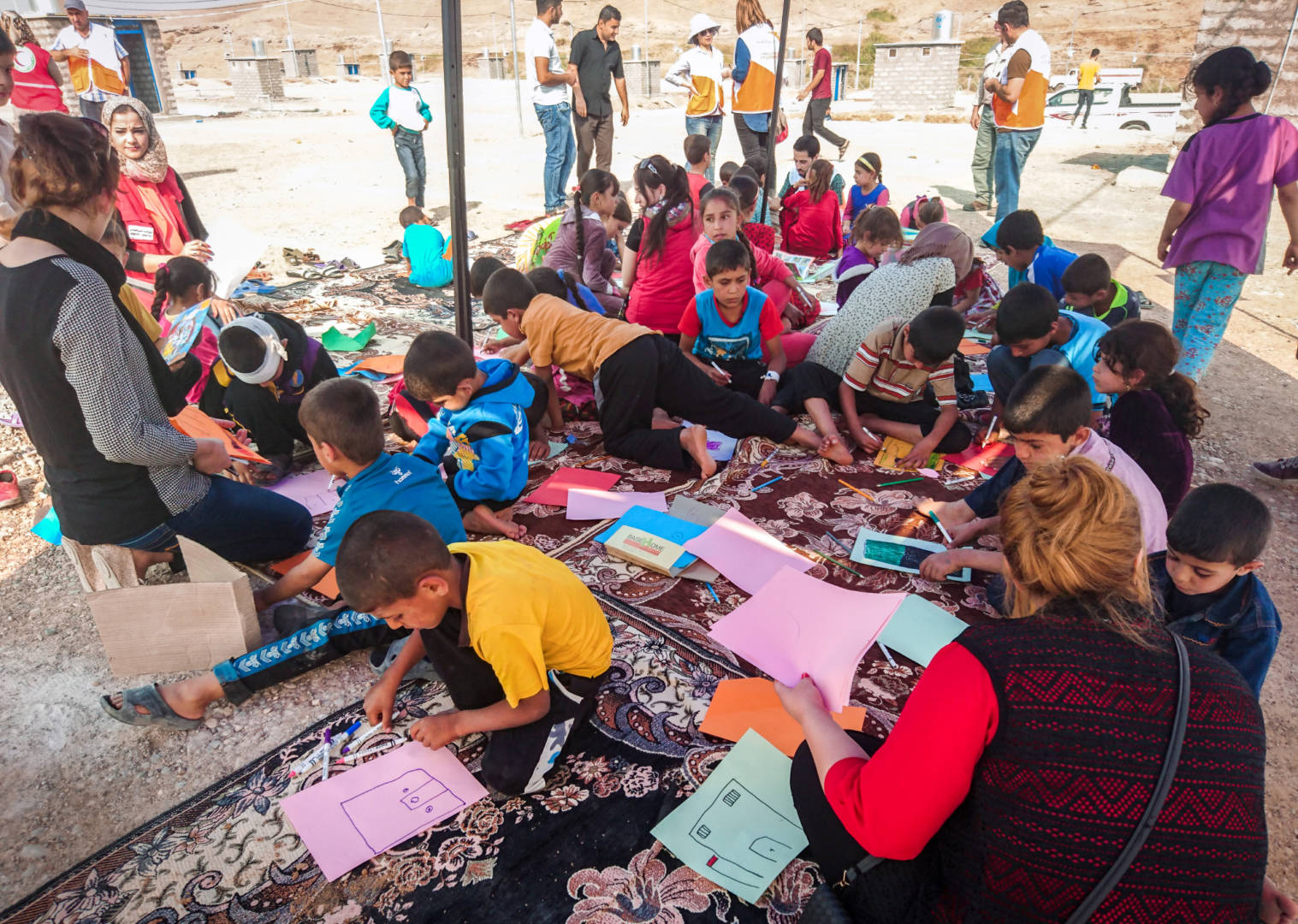 Children whose families have fled conflict in villages near Mosul, Iraq, play and draw in a World Vision Child-Friendly Space in Zelican camp. (©2016 Nick Ralph/World Vision)