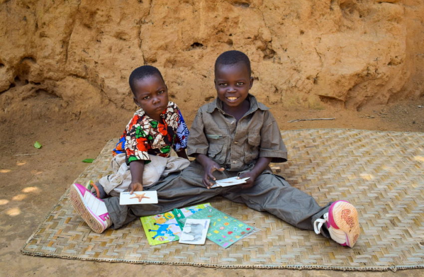 Sponsored boy Jean de Dieu (right) plays with his brother with the toys sent by his sponsor.
