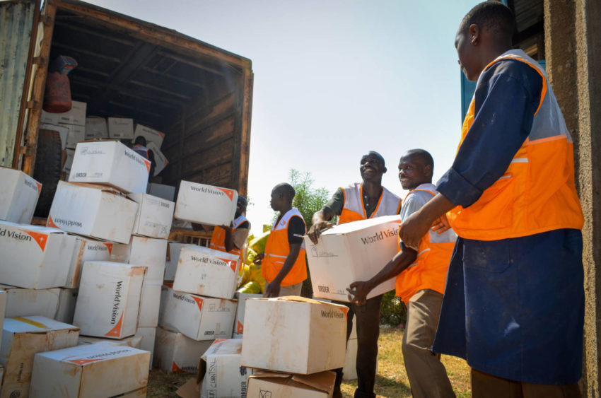 World Vision staff unload boxes of relief goods in South Sudan.