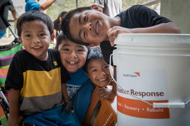 Children at at Bethel Assemblies of God Church in Immokalee, Florida play near a storm clean-up kit while their parents collect Hurricane Irma relief supplies.