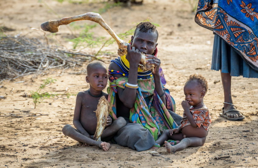 Mother and her children eating marrow from a donkey bone. The East Africa hunger and food crisis is one of the worst disasters of 2017.