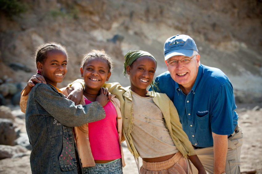 Rich Stearns, World Vision U.S. president, poses for pictures with a group of village girls who have come to collect water in southeastern Ethiopia. (©2009 World Vision/photo by Jon Warren)