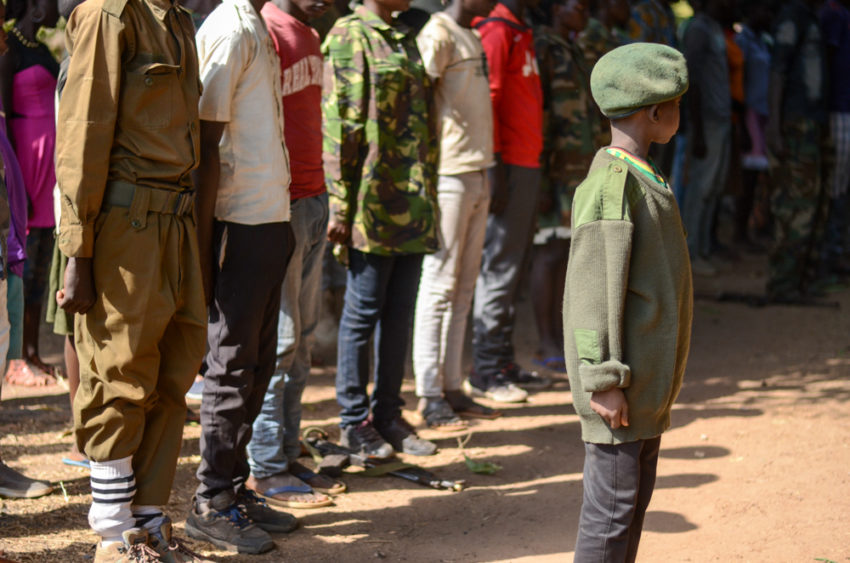 Boy at attention with other youth after being released by armed group in South Sudan.