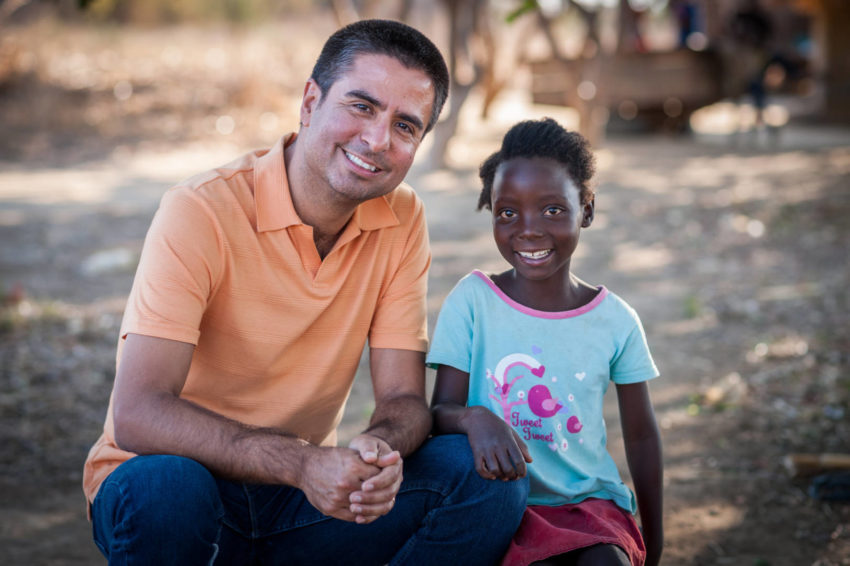 World Vision U.S. President-elect Edgar Sandoval poses with 8-year-old Faith, his World Vision sponsored child, in Kapululwe, Zambia.