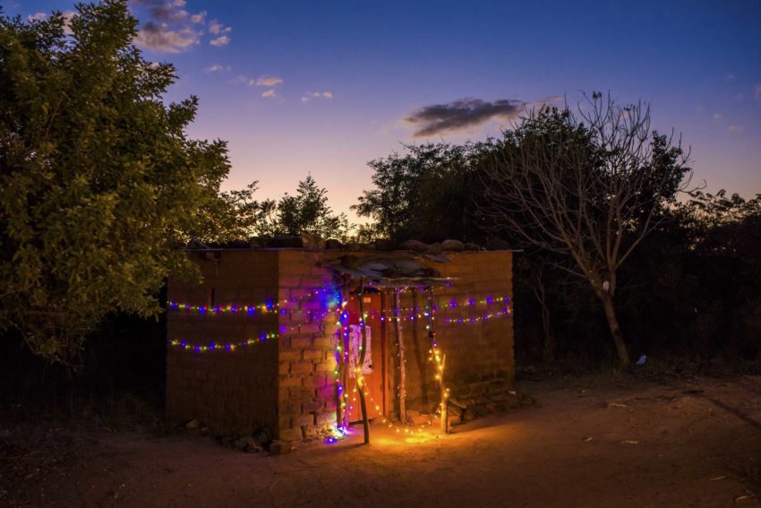 Battery-powered Christmas lights hang on the house of a sponsored child in Zambia.