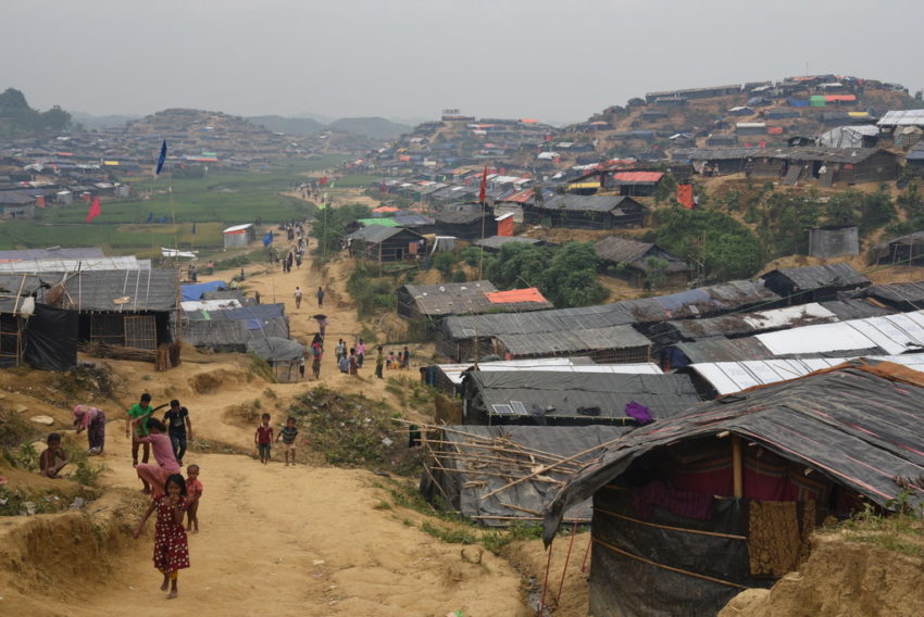Refugees from Myanmar walk among a landscape of makeshift shelters and tents in a refugee camp in Bangladesh. The refugee crisis in Bangladesh is one of the worst disasters of 2018.