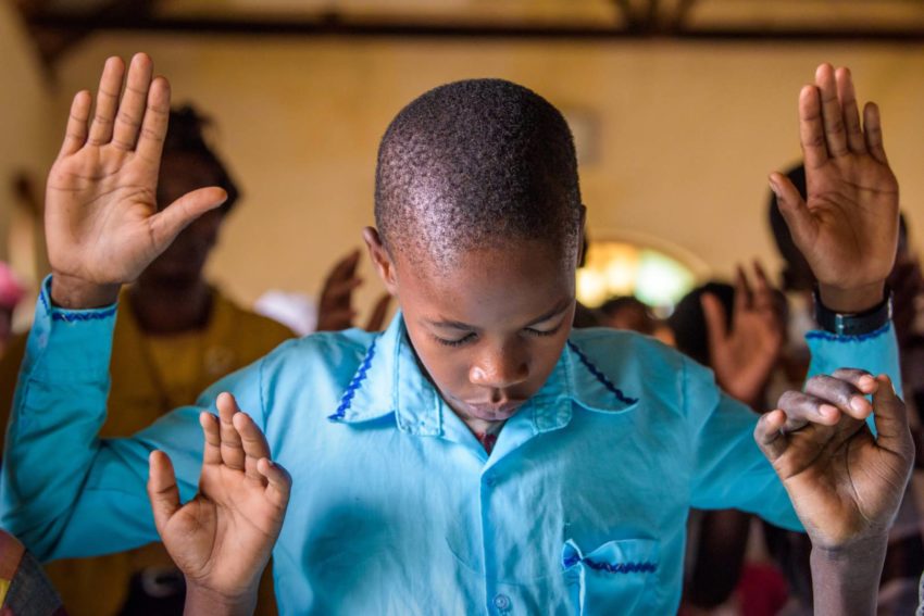Photos of worship and praise: This Easter, World Vision brings you photos of fellow believers around the world celebrating and worshipping our Lord, Jesus Christ. A boy worships during church services in Kenya.