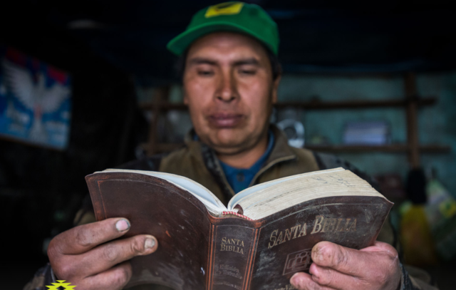 Feliciano Rimachi Ramirez's hands tell his story and the story of his village, Carhuahuran, Peru. The Bible he holds was given to him by World Vision staff.