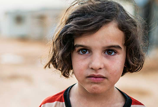 Sedra, 7, her parents, and her six siblings, ages 1 to 11, feared for their lives as they fled their war-torn nation, running away with only the clothes on their backs as they headed to the Jordanian border. They now live in Za'atari Refugee Camp in Jordan.