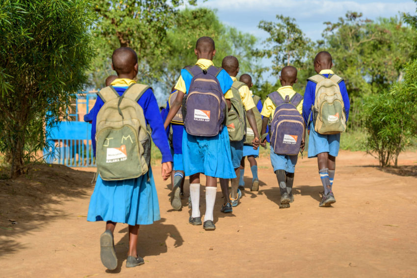 School children head home after class, wearing their World Vision backpacks in Kalawa Area Program in Kenya.