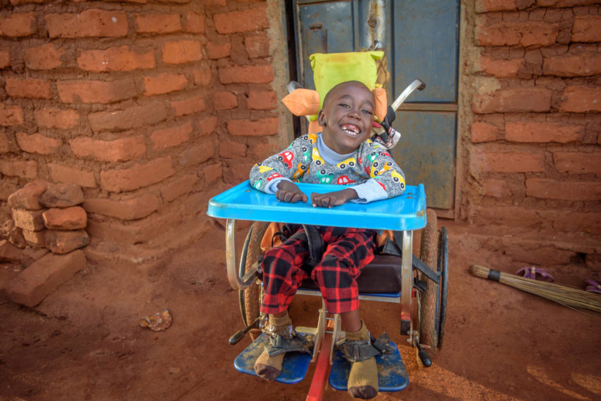 Dennis Ngumbau is all smiles in his new wheelchair.