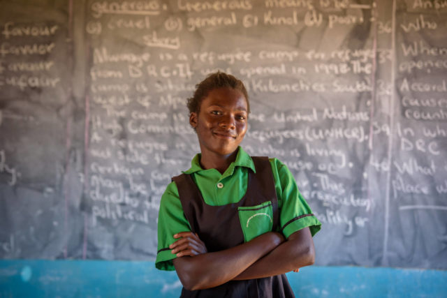 Felistus Malyoongo, 15, was lured into child marriage at age 14, but the local child protection committee brought her back home. Now 15, she stands in a classroom of the school she attends in rural Zambia.