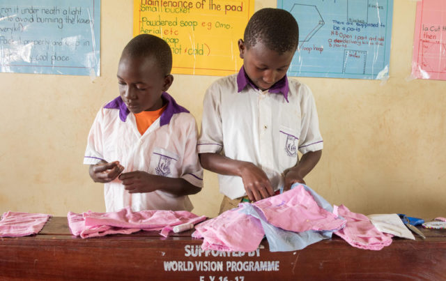 Boys sew fabric as part of a WASH club learning to make menstrual pads. Globally, girls in developing countries often miss school while on their periods. By missing class for up to a week each month, it often leads to them dropping out altogether. World Vision works with Sesame Workshop to help change that by teaching both boys and girls how to make hygienic reusable menstrual pads so girls can still attend class while on their periods.
