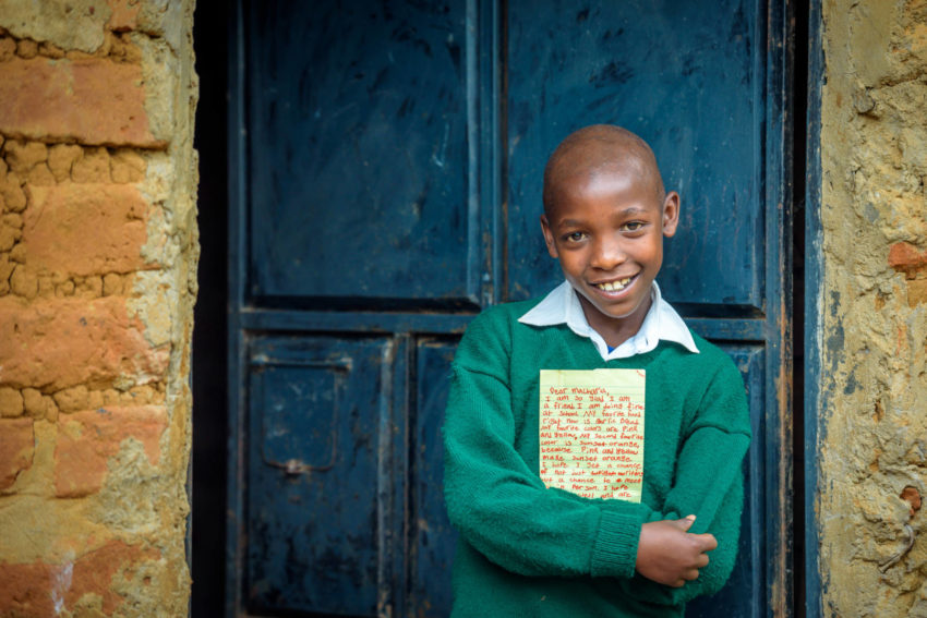 World Vision sponsored child Macharia hugs a letter that he just received from his sponsor. Travel along with a letter to a sponsored child to learn all the steps involved in getting it from your desk to the child’s hands and then the child’s response back to you.