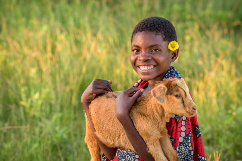 Rosemary holds one of the goats she received through the World Vision Gift Catalog. Rosemary benefited from drinking goat’s milk, which provided nutritional support so she could be healthy, not hungry.