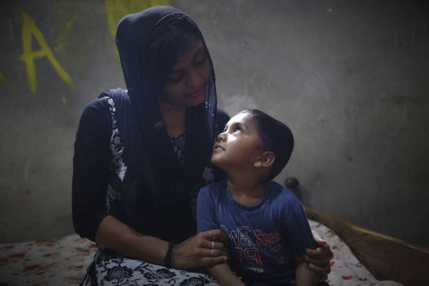 Masrafi gazes up at his mother at his home in Bangladesh. He had the opportunity to choose his sponsor last year and chose World Vision U.S. President Edgar Sandoval Sr. and his wife, Leiza.