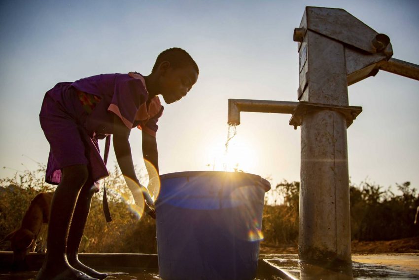 Ireen gets water at the new borehole well installed in her community. Having clean water will be a game changer for her future.