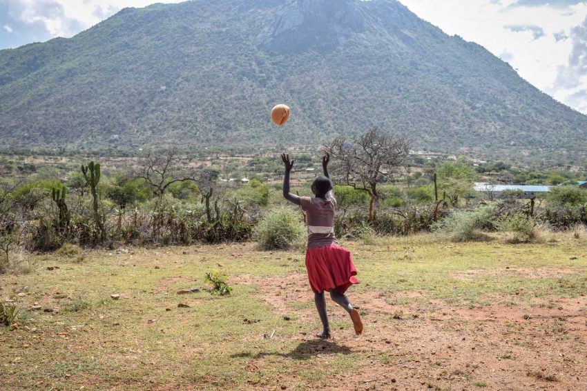 Mary plays with a ball outside the school World Vision started for children escaping child marriage and FGM. There she now attends classes and recovers from her child marriage.