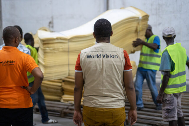 Relief workers in Haiti load supplies for distribution