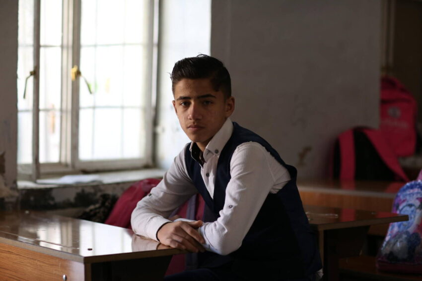 A teenage Iraqi boy continues his education with the support of World Vision.