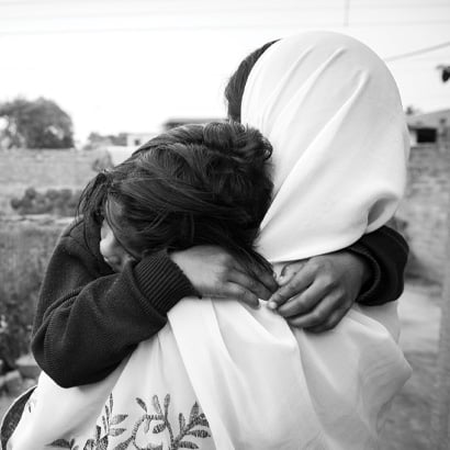 little girl being held by a woman