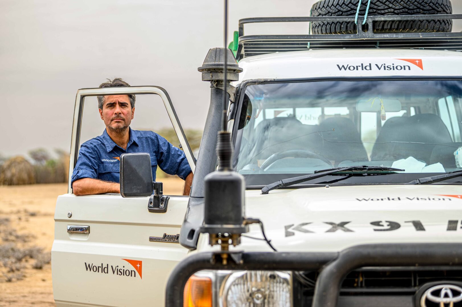 edgar standing outside a world vision truck