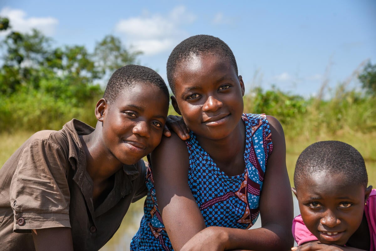 Close-up photo of 3 girls in Ghana smiling.
