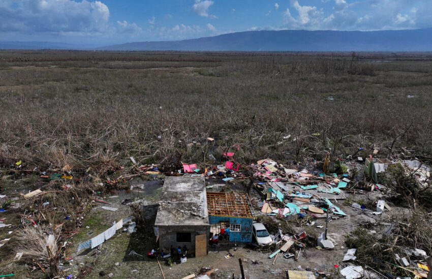 Debris surrounds a residence that is partially destroyed in a field after a hurricane makes landfall in Jamaica.
