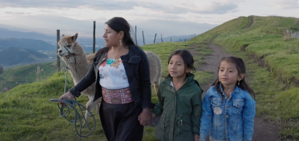 two kids holding hands with the older woman