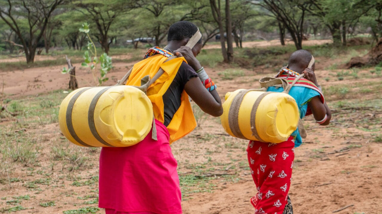 Women and girls walk to collect water in Rumate, Kenya. The images accompany new research documenting the time, distance, and physical burden women and girls face each day to access water.