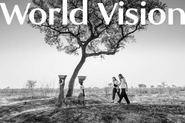 World Vision nameplate over a black and white image of two girls in Ghana walking with two American girls following them.