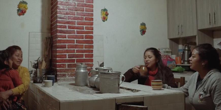image of women sitting around a table talking