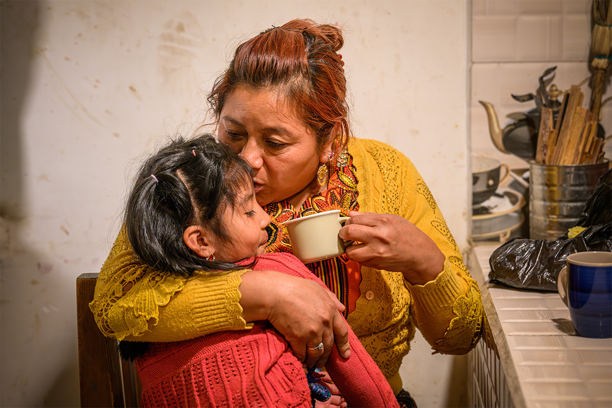 woman kissing her child