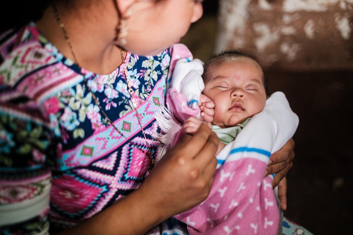 A mother holds her 2-month-old baby in Honduras.