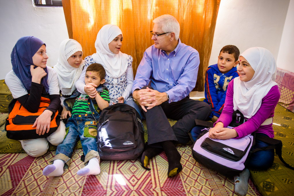Rich Stearns sitting with Syrian refugees
