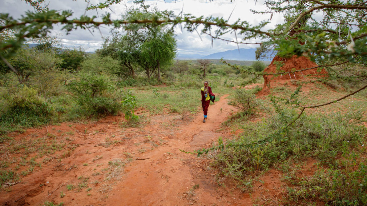 Naomi walks through the wilderness to the place she used to collect water. Now she and her family enjoy access to clean water. (©2016 World Vision, Chris Huber)