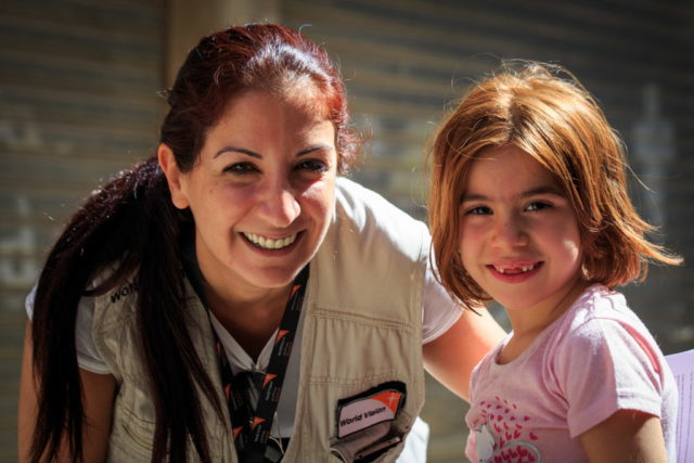 Aid worker with Syrian refugee child in Lebanon