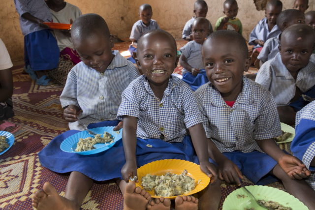 Children enjoy a nutritious meal at a World Vision program in Rwanda. PHOTO: World Vision / Ilana Rose